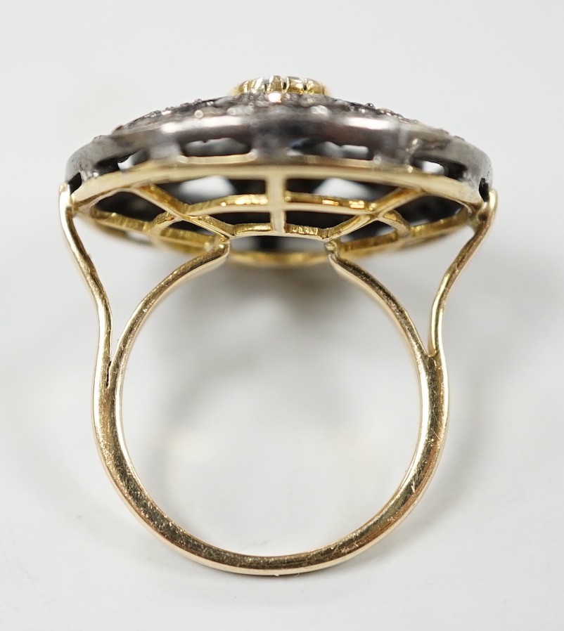An Indian pierced yellow metal, sapphire and rose cut diamond set circular cluster ring, size N/O, gross weight 8.4 grams.